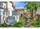 Landscaped backyard featuring a stone walkway, lush plants, and privacy fence at 13850 Sunset Dr, Largo, FL 33774