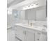 Bright bathroom with a large mirror, cabinets, and modern fixtures at 13850 Sunset Dr, Largo, FL 33774