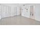 A bright bedroom with tile flooring and access to an adjacent bathroom and closets at 13850 Sunset Dr, Largo, FL 33774