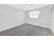 Bedroom features neutral carpet, ceiling fan, and built-in closet at 13850 Sunset Dr, Largo, FL 33774