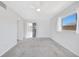 Bedroom features neutral carpet, a ceiling fan, and sliding glass doors to a patio at 13850 Sunset Dr, Largo, FL 33774