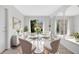 Bright dining room featuring a glass table, seating for four, and abundant natural light at 13850 Sunset Dr, Largo, FL 33774