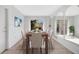 Bright dining room with a wooden table, seating for eight, and a sliding door to the outside at 13850 Sunset Dr, Largo, FL 33774