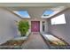 Inviting entryway featuring a beautiful front door, skylights, and stone walkway and flower beds at 13850 Sunset Dr, Largo, FL 33774