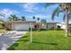 Charming single-story home features a well-manicured lawn and a bright pink front door at 13850 Sunset Dr, Largo, FL 33774