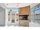 Relaxing sunroom featuring a stone fireplace and access to the outdoors at 13850 Sunset Dr, Largo, FL 33774