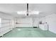 Well-lit garage featuring ample storage, a laundry area and access to the home at 13850 Sunset Dr, Largo, FL 33774