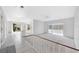Bright, open hallway features neutral tile flooring and carpeted floors leading to the sunroom at 13850 Sunset Dr, Largo, FL 33774