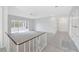 Bright hallway with tile flooring and carpeted floors, complemented by a white brick wall at 13850 Sunset Dr, Largo, FL 33774