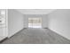 Bright living room featuring white brick walls and access to the sunroom at 13850 Sunset Dr, Largo, FL 33774
