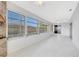 Relaxing sunroom with stone fireplace is surrounded by ample natural light at 13850 Sunset Dr, Largo, FL 33774