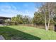 Green fenced backyard with a covered porch perfect for outdoor activities and relaxation at 14241 Natures Reserve Dr, Lithia, FL 33547