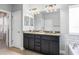 Bathroom featuring double vanity, granite countertops, and well-lit mirror at 14241 Natures Reserve Dr, Lithia, FL 33547
