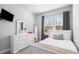 Cozy bedroom with carpeting, a comfortable bed, and large window with plenty of light at 14241 Natures Reserve Dr, Lithia, FL 33547