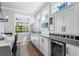Dining area features custom cabinets, a wine refrigerator, and natural light at 14241 Natures Reserve Dr, Lithia, FL 33547