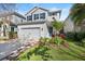 Charming two-story home with a manicured lawn, tidy landscaping and a gray painted garage at 14241 Natures Reserve Dr, Lithia, FL 33547