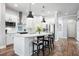 Bright kitchen features white cabinets, stainless steel appliances, and a large island with bar seating at 14241 Natures Reserve Dr, Lithia, FL 33547