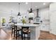 Open kitchen with white cabinets, stainless steel appliances, and a large island with seating for three at 14241 Natures Reserve Dr, Lithia, FL 33547
