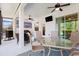 Enclosed patio area featuring ceiling fans, outdoor furniture, and views of the yard at 14241 Natures Reserve Dr, Lithia, FL 33547