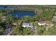 Aerial view of home near a lake with a playground, lush landscaping and circular driveway at 16121 Carencia Ln, Odessa, FL 33556