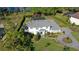 Two-story home boasts mature trees, lush lawn, and proximity to community playground at 16121 Carencia Ln, Odessa, FL 33556