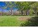 Expansive backyard featuring mature trees, lush lawn, and serene lake views at 16121 Carencia Ln, Odessa, FL 33556