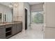 Bathroom boasting a soaking tub, gray vanity with granite counters, and modern lighting at 16121 Carencia Ln, Odessa, FL 33556