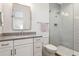 Bathroom with vanity and framed mirror, leading to frameless glass shower at 16121 Carencia Ln, Odessa, FL 33556