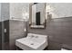Elegant bathroom with stylish tile, a pedestal sink, and sconce lighting for a modern feel at 16121 Carencia Ln, Odessa, FL 33556