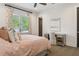Charming bedroom with a desk, comfortable bed, and natural light from the window at 16121 Carencia Ln, Odessa, FL 33556