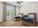 Spacious bedroom with two beds, a ceiling fan, and natural light from a large window at 16121 Carencia Ln, Odessa, FL 33556