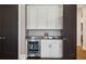 Butler's pantry with custom cabinets, granite countertops, and a beverage refrigerator at 16121 Carencia Ln, Odessa, FL 33556