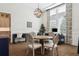 Bright dining area features a round wooden table, and large windows at 16121 Carencia Ln, Odessa, FL 33556
