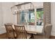 Dining room with a large window providing a view of the backyard and outdoor living space at 16121 Carencia Ln, Odessa, FL 33556