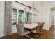 Bright dining room with hardwood floors, stylish light fixture, and a large window with a view at 16121 Carencia Ln, Odessa, FL 33556