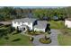 Stately two-story home with circular driveway and landscaping near a lake at 16121 Carencia Ln, Odessa, FL 33556