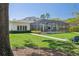 The large backyard includes a screened pool, well-manicured lawn, and lush landscaping at 16121 Carencia Ln, Odessa, FL 33556