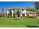 Expansive lawn and meticulous landscaping surround this stunning two-story home with stone and siding accents at 16121 Carencia Ln, Odessa, FL 33556