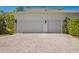 Spacious two-car garage with brick driveway and professionally landscaped surroundings at 16121 Carencia Ln, Odessa, FL 33556