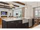 Open concept kitchen with a large island, stainless steel appliances, and exposed beams at 16121 Carencia Ln, Odessa, FL 33556