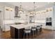 The modern kitchen features a large center island, stainless appliances, and ample cabinet space at 16121 Carencia Ln, Odessa, FL 33556