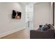 Cozy living room area with modern furnishings, hardwood floors, and a mounted television at 16121 Carencia Ln, Odessa, FL 33556