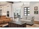Open-concept living room offers stylish furniture, hardwood floors, and seamless flow to the kitchen at 16121 Carencia Ln, Odessa, FL 33556