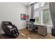 Comfortable home office with a large desk, comfortable chair, and natural light from the windows at 16121 Carencia Ln, Odessa, FL 33556