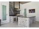 Well-appointed outdoor kitchen featuring grill, sink, granite countertops, and mounted television at 16121 Carencia Ln, Odessa, FL 33556