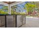 Outdoor kitchen with stainless steel refrigerator, stone accents, and poolside views at 16121 Carencia Ln, Odessa, FL 33556