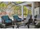 Outdoor seating area with comfortable armchairs overlooking the pool and backyard at 16121 Carencia Ln, Odessa, FL 33556