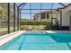 The screened pool and spa includes lounge seating outside with an inviting backyard view at 16121 Carencia Ln, Odessa, FL 33556