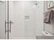 Modern shower with herringbone tile, a glass door, and a built-in niche for storage at 16121 Carencia Ln, Odessa, FL 33556