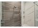 Detailed view of the shower with gray and white marble tiling, and dual shower heads at 16121 Carencia Ln, Odessa, FL 33556
